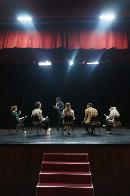 A group of actors rehearsing on stage under spotlights, creating an immersive theater experience.